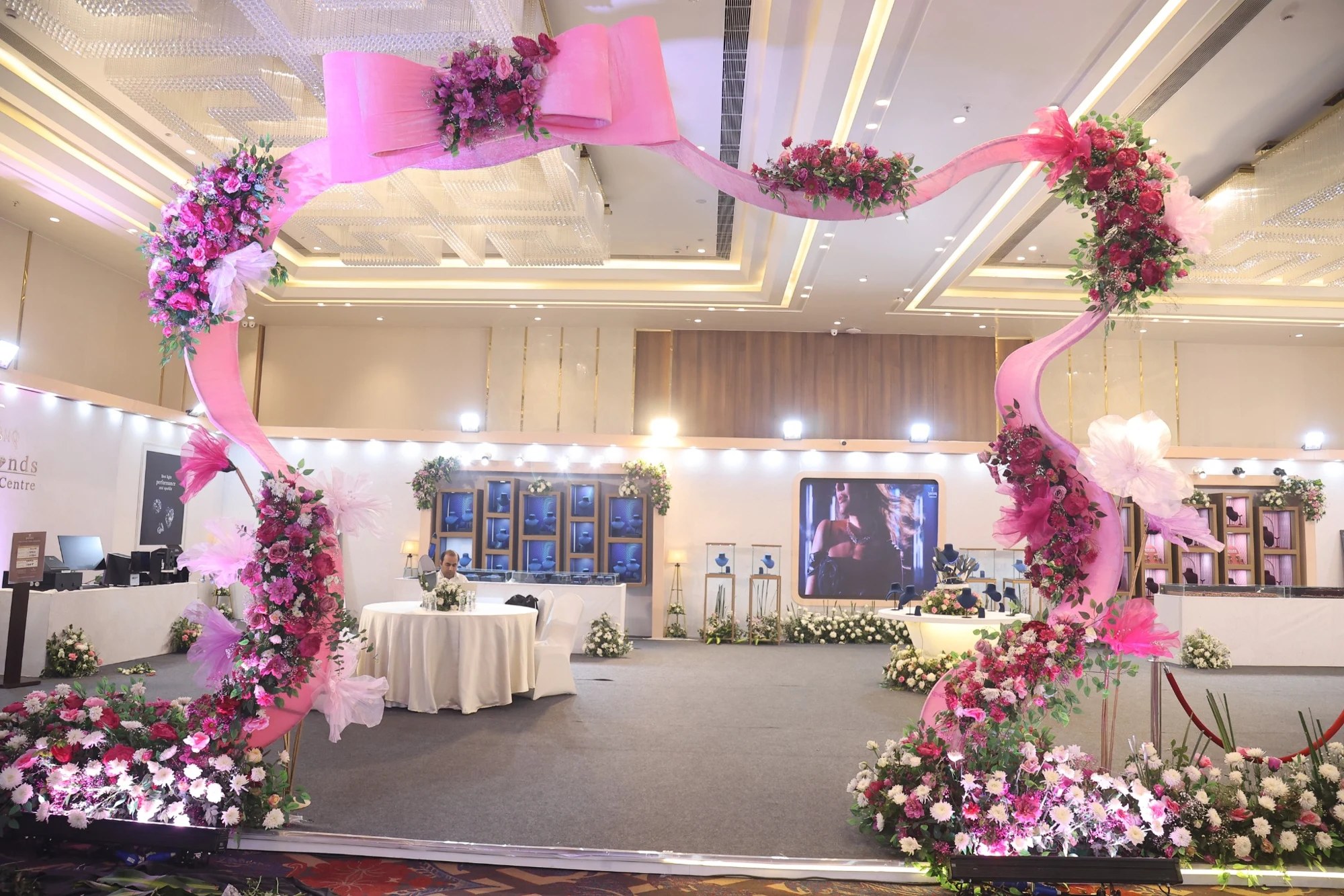 Sculptural floral installation framing a brand exhibition entrance